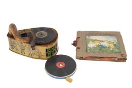 A vintage tin plate child's clockwork toy record player with discs.