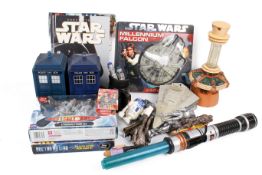 A collection of assorted modern Star Wars and Doctor Who related toys and books.