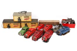 A collection of vintage Schuco Kommando Anno 2000 clockwork tin plate cars and three 'Garage No.