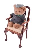A miniature 20th century mahogany carver armchair in the Chippendale style with a teddy bear.