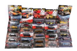 A collection of carded Hotwheels diecast model cars.