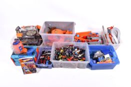 A large collection of assorted Mattel Hot Wheels diecast vehicles, garages and track.