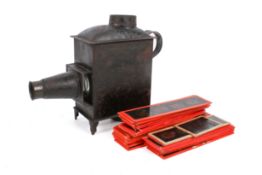 A small early 20th century magic lantern with coloured glass slides. With oil lamp.