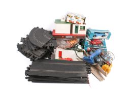 A collection of assorted vintage Scalextric slot car racing items.