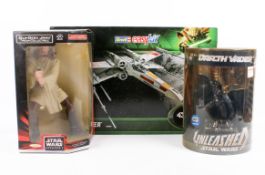 A group of three assorted Star Wars collectables.