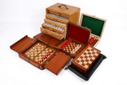 A collection of four assorted travelling chess sets with a Mah-Jongg set by Jackpot.