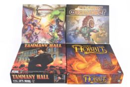 A collection of four assorted modern board games.
