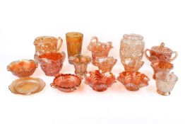 A collection of Marigold carnival glass. Consisting of vases, jugs, small dishes and a cup.