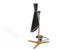 A contemporary adjustable table lamp with a crow's foot base. Adjustable, black perforated shade.