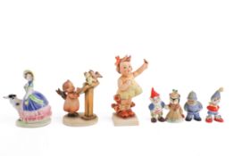 A collection of small, vintage ceramic figures, Including porcelain figure of girl with dog,