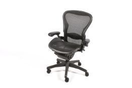 A Herman Miller 'Aeron' contemporary black mesh office elbow chair.