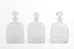 Three Dartington hand-blown, textured glass decanters with stoppers.