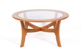 A mid-century G-Plan style beech coffee table with inset glass top.