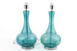 A pair of contemporary turquoise glass bottle shaped table lamps.