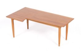 A mid-century Vanson teak coffee table. Shaped top sat on tapering beech legs.