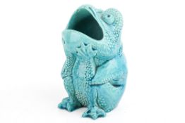 A ceramic, Burmantofts turquoise glazed toad spoon warmer.