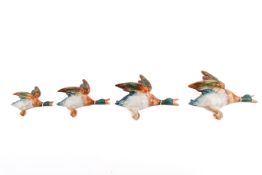 A set of four 20th century Beswick ceramic wall hanging flying ducks.