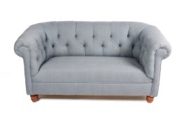 A contemporary chesterfield sofa in duck egg blue upholstery. Button back and stained beech feet.