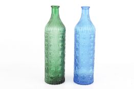 A pair of vintage coloured glass bottles with repeating geometric pattern.