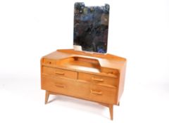 A mid-20th century G-Plan, E Gomme light oak dressing table with mirror.