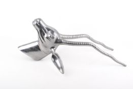 A modern polished metal wall mounted antelope head sculpture.