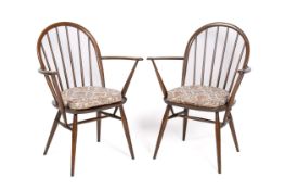 A pair of mid-century Ercol Windsor open armchairs.