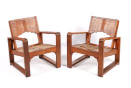 A pair of 20th century Art Deco style teak armchairs.