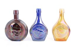 Three 20th century iridescent carnival glass flasks from Wheaton.