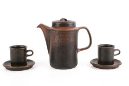 A vintage Arabia Ruska coffee pot with two cups and saucers. Brown and black speckle glaze.