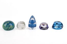 Five blue and colourless glass paperweights.