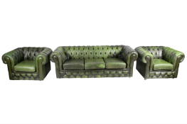 A green button-back Chesterfield three-seater sofa and two matching chairs on castors.