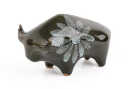 A Lotus Studio pottery bull with green glazed flowerhead decoration.