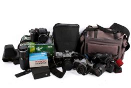 Group of assorted film cameras and accessories. Including an Olympus OM10 outfit, etc.