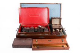 A group of vintage wooden boxes and small leather case.