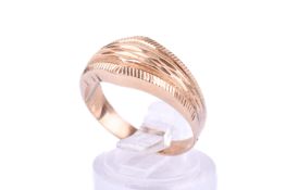 An unmarked yellow metal dress ring. With textured design, tested as 18ct gold, size P, weight 2.4g.