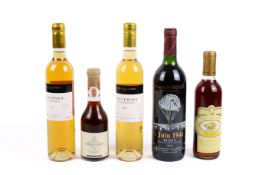 A group of five bottles of wine.