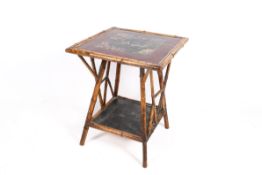 A Victorian bamboo occasional table. Having a painted top and a lower tier.