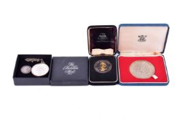 Three commemorative sterling silver medallions and a coin.