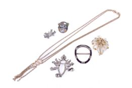 Five costume brooches and a yellow metal necklace.