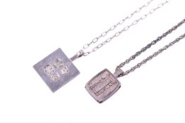 Two silver necklaces and pendants.