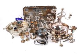 A box of assorted silver plate. Including a pair of candlesticks, a tea pot and a tray, etc.