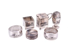 A set of six Egyptian silver plated items with scenes.
