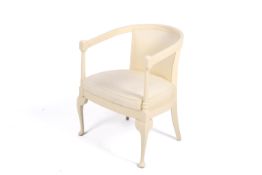 A cream painted open arm tub chair.