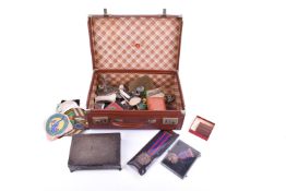 A small vintage suitcase of military and other collectables.