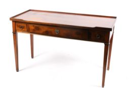 A 20th century Georgian style oak writing table or desk with three drawers.