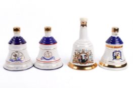 A group of four assorted Royal Commemorative Bell's Whisky decanters with contents, boxed.