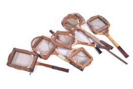 A collection of assorted vintage tennis, badminton and squash racquets, mostly wooden with press.