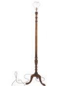 A 20th century Georgian style mahogany standard lamp. Raised on a tripod base with pad feet.