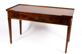 A 20th century Georgian style oak writing table or desk with three drawers.