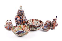 Group of nine assorted Japanese Imari ceramic items. Including bowls, tea pots and a bud vase, etc.